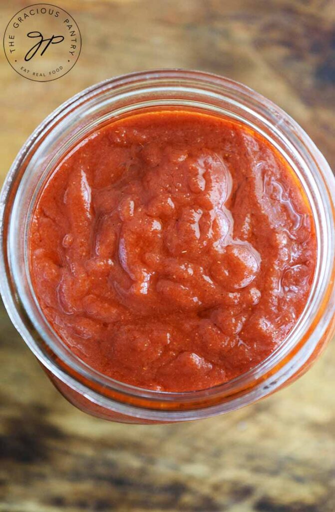 An overhead view looking down into an open quart size canning jar filled with Maple BBQ Sauce.