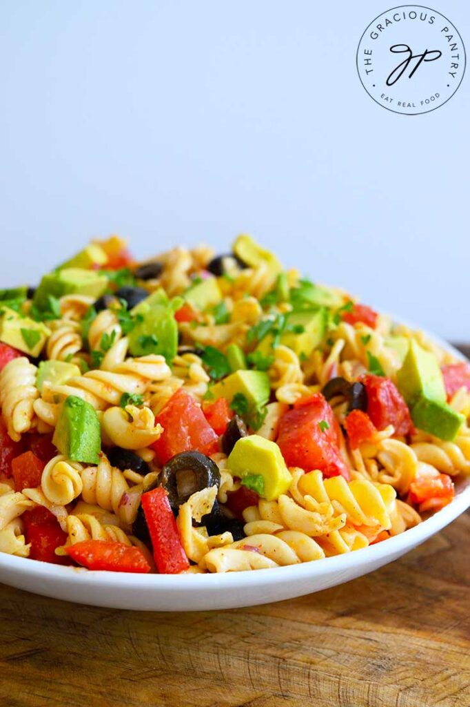 A side view of a white bowl filled with this Mexican Pasta Salad.