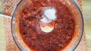 Salt added to the salsa in the processor for adjusting to taste.