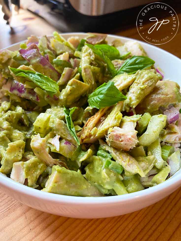 An overhead view of a white bowl filled with this lemon chicken salad recipe.