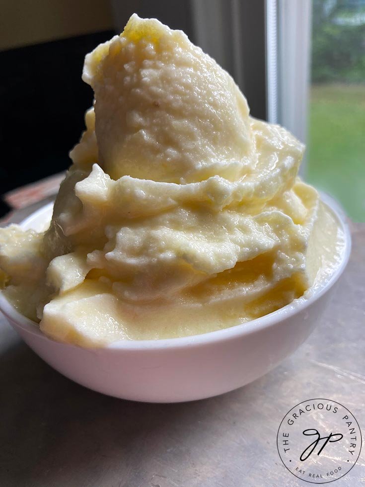 An up close shot of a white bowl filled with Pineapple Whip.