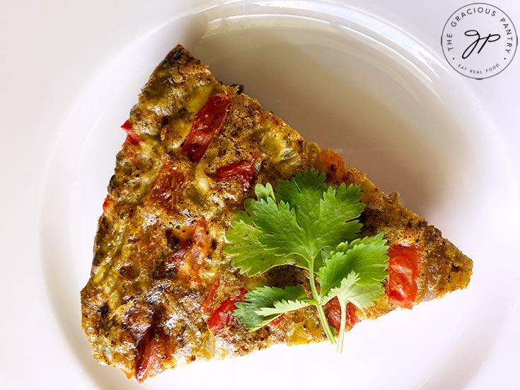 A single slice of the finished Southwestern Crustless Quiche Recipe on a white plate.