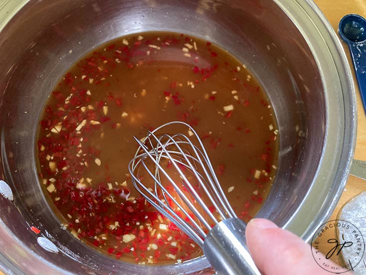 Whisking all the ingredients together in a pot.