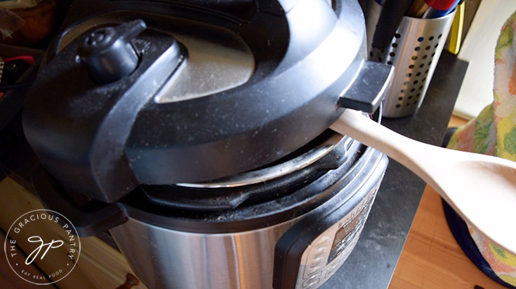 Venting the lid on the Instant Pot to further reduce the apple sauce to apple butter.