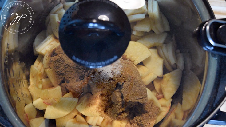 Securing the slow cooker lid to slow cook this Amish Apple Butter Recipe.