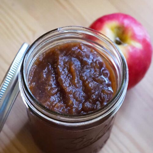 A side view looking down into a canning jar filled with this Amish Apple Butter Recipe.