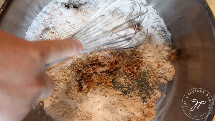 Whisking all the dry ingredients together in a large mixing bowl.