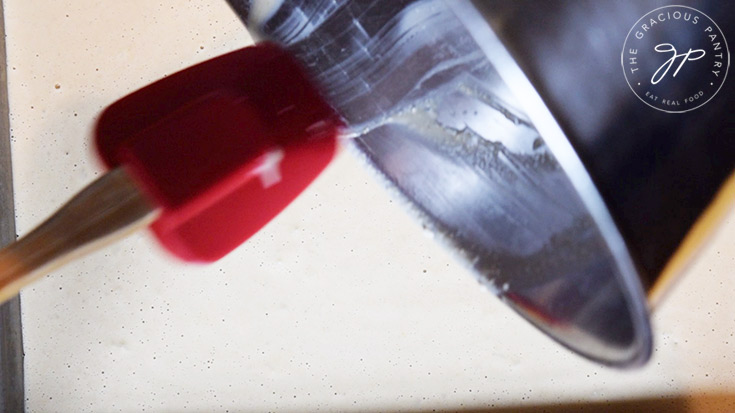 Pouring the batter onto the sheet pan.