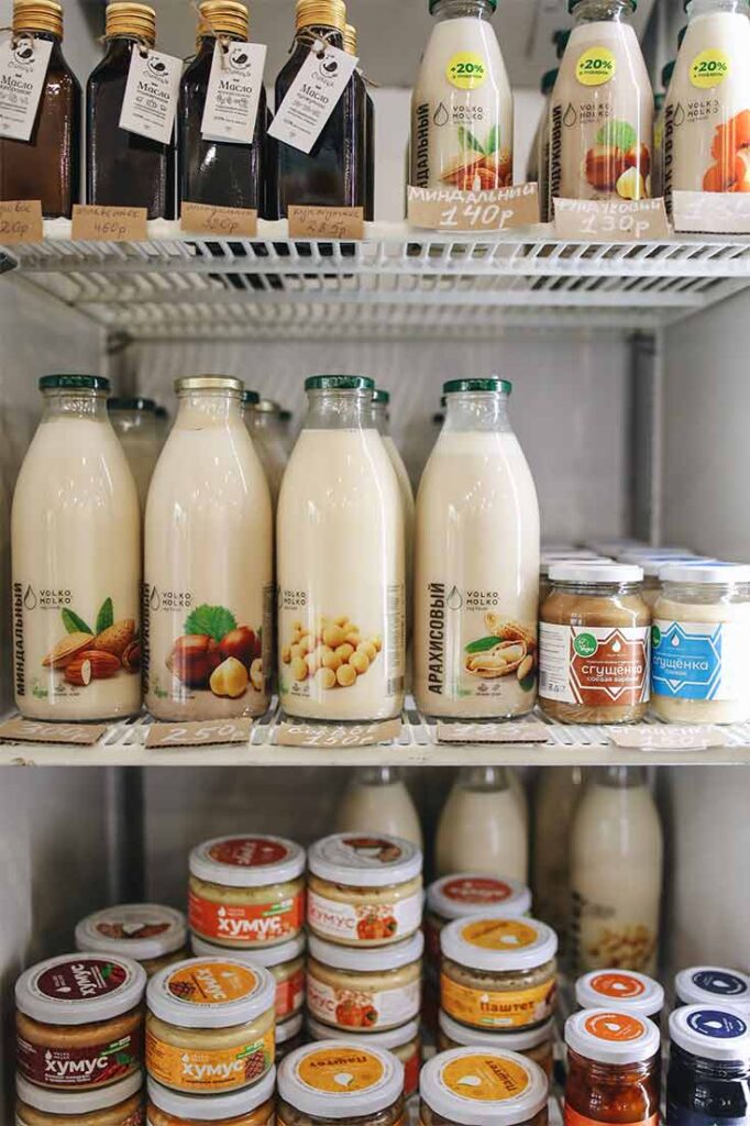 A fridge filled with healthy dairy free snacks and milks.