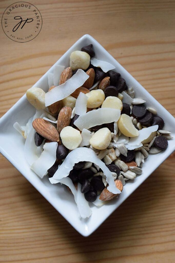 An overhead view looking down into a square, white dish filled with Low Carb Trail Mix.