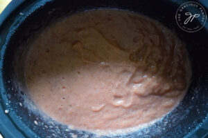 The pureéd Strawberry Apple Sauce in a slow cooker.