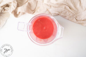 Blended strawberries in a blender cup.
