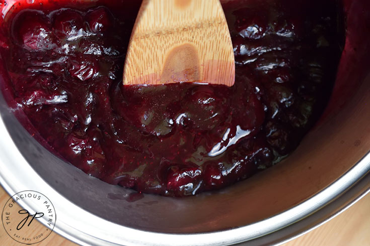 The thickened blueberry syrup in a pot.