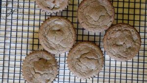 Butternut Squash Muffins cooling on a black, wire, cooling rack.