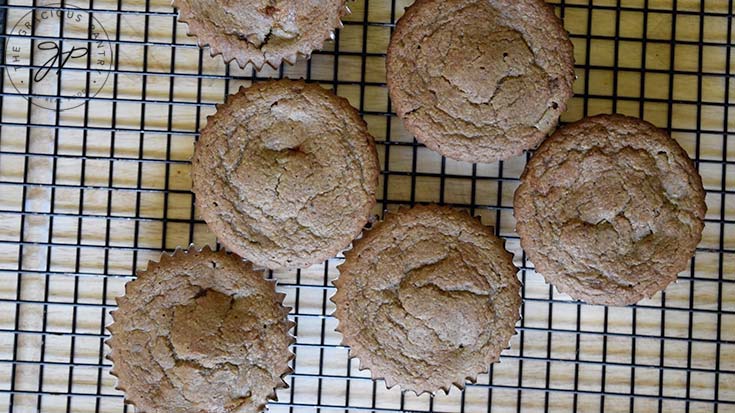 Butternut Squash Muffins cooling on a black, wire, cooling rack.