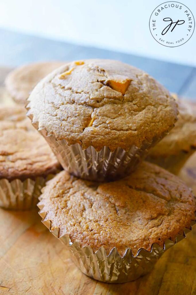 Four Butternut Squash Muffins together with a fifth sitting on top of them.