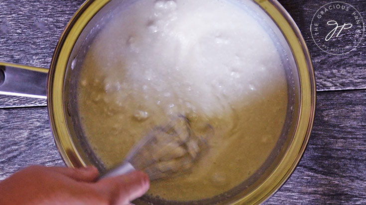 Whisking all the ingredients together in a pot.