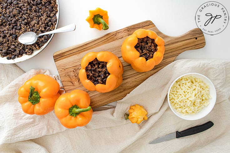 Filling Jack-O-Lantern Stuffed Peppers with meat mixture.