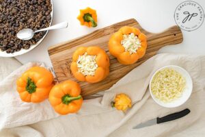 Topping the pepper filling with cheese.