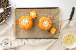 Placing the peppers on a baking pan.