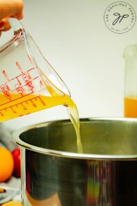 Pouring the cider into the pot.