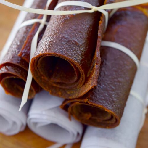 A pile of Pumpkin Fruit Leather on a cutting board.