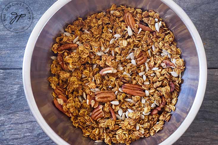 Pumpkin Granola in a stainless steel mixing bowl.