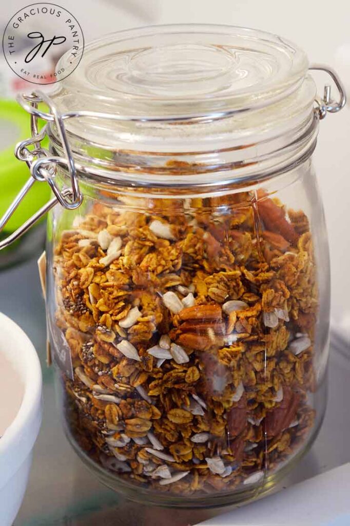 Pumpkin Granola in a closed jar sitting in the fridge.