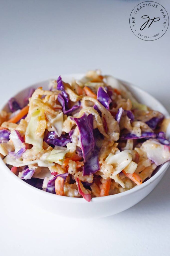 A front view of this Apple Slaw Recipe in a small, white bowl.