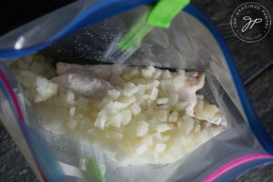 Chopped frozen onions added to the freezer bag.