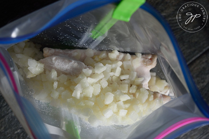 Chopped frozen onions added to the freezer bag.