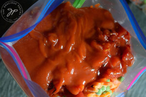 Tomato sauce added to the freezer bag.