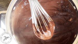 The thickened chocolate pie filling in a pot.