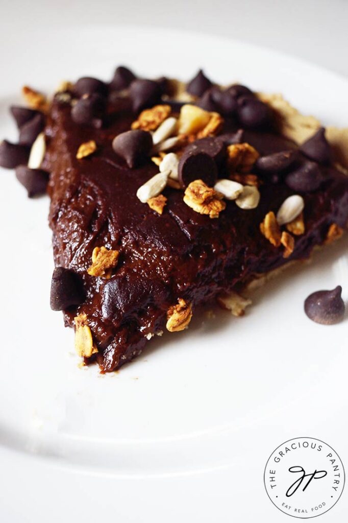 a side view of a single slice of Easy Homemade Chocolate Pie on a white plate.