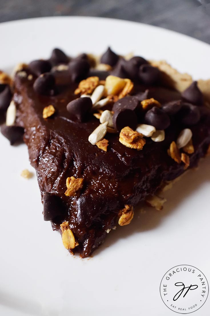 A close up shot of a single slice of this Easy Homemade Chocolate Pie on a white plate.