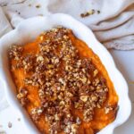 The finished Healthy Sweet Potato Casserole in a white casserole dish.