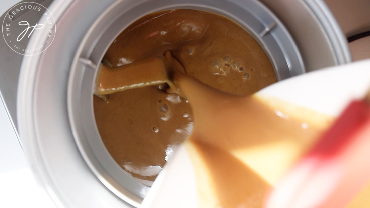 Pouring the ice cream base into an ice cream maker.