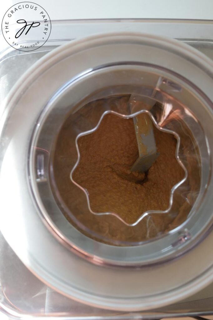 An overhead shot of the ice cream base churning in the ice cream maker.