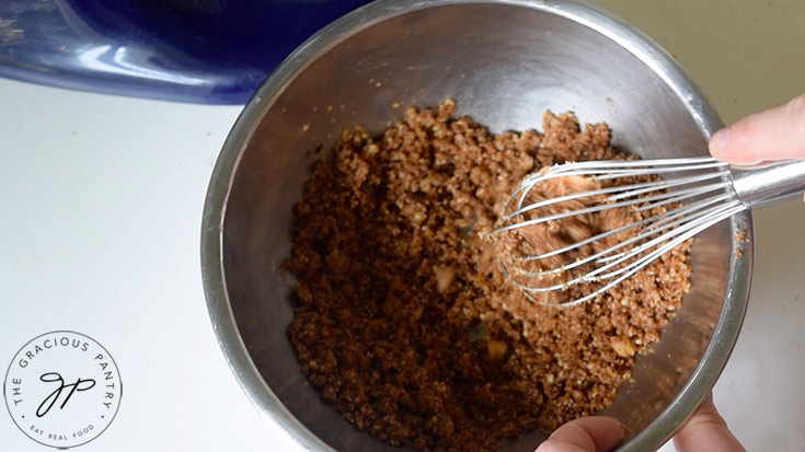 The Snickerdoodle topping getting mixed together in a mixing bowl with a whisk.