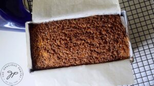 Cooling the loaf of Snickerdoodle Pumpkin Bread on a wire rack after baking.