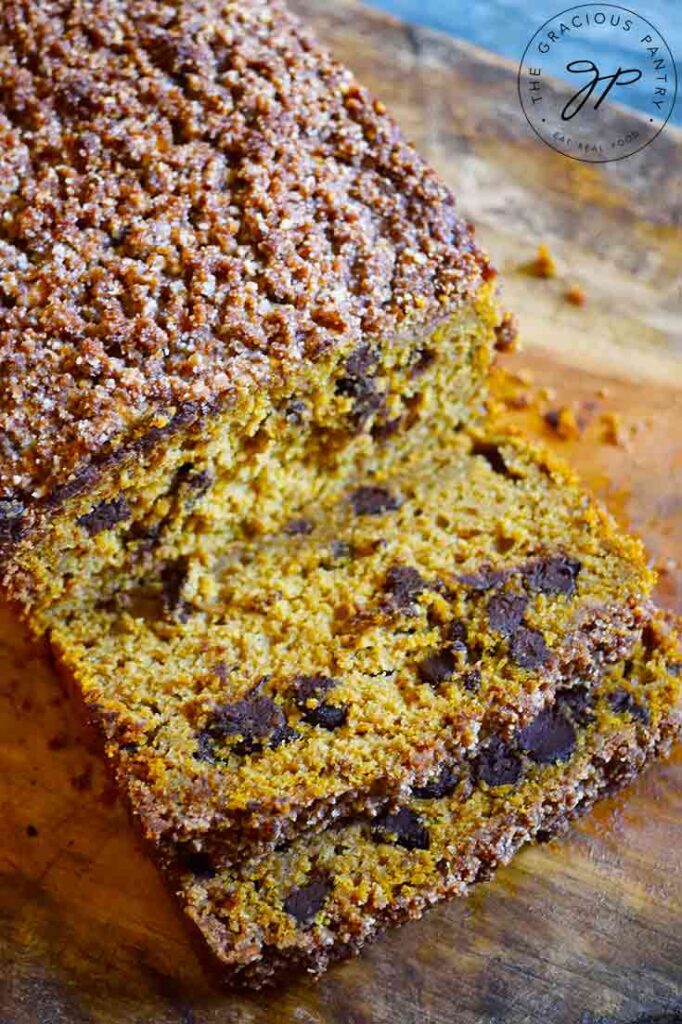 An overhead view of this Snickerdoodle Pumpkin Bread with two slices cut off the front.