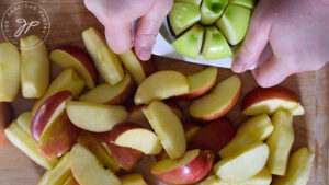 Cutting and coring apples on a cutting board.