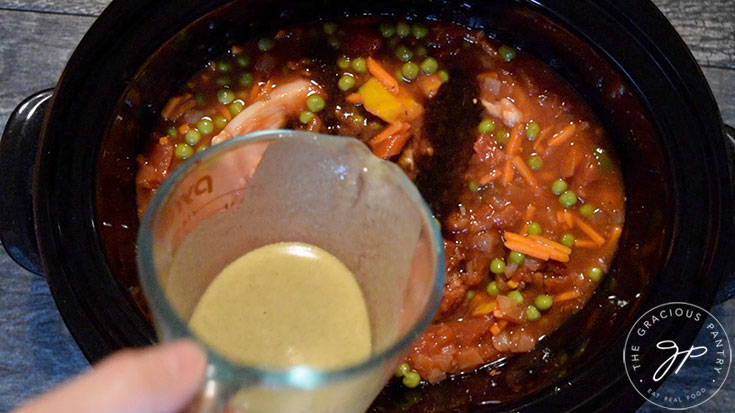 Adding Italian dressing the the crock for this Crockpot Italian Chicken Recipe.