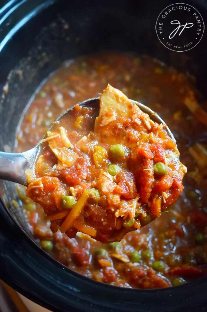 A ladle lifts a scoop of this Crockpot Italian Chicken Recipe out of the crockpot and towards the camera.