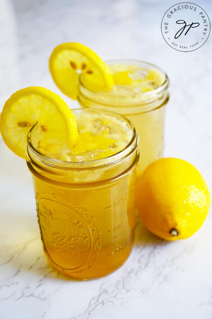 A side view of two glasses, lined up and filled with Lemon Drop Mocktail.