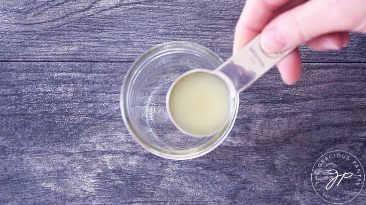 Adding lime juice to a canning jar.