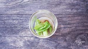 Mint leaves added to a canning jar.