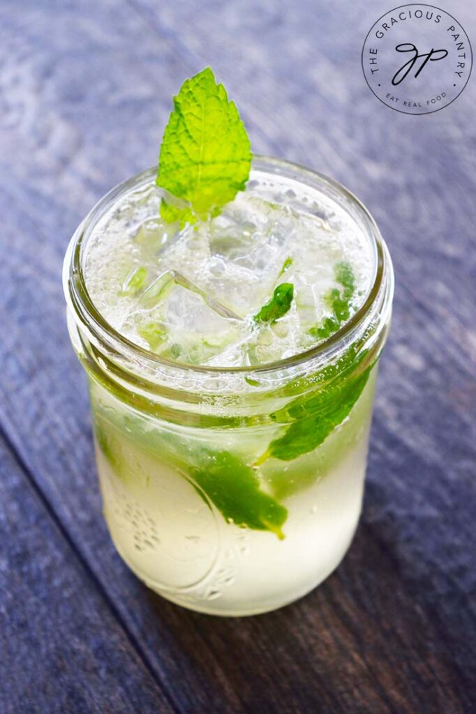 A side view of a mojito mocktail in a canning jar.