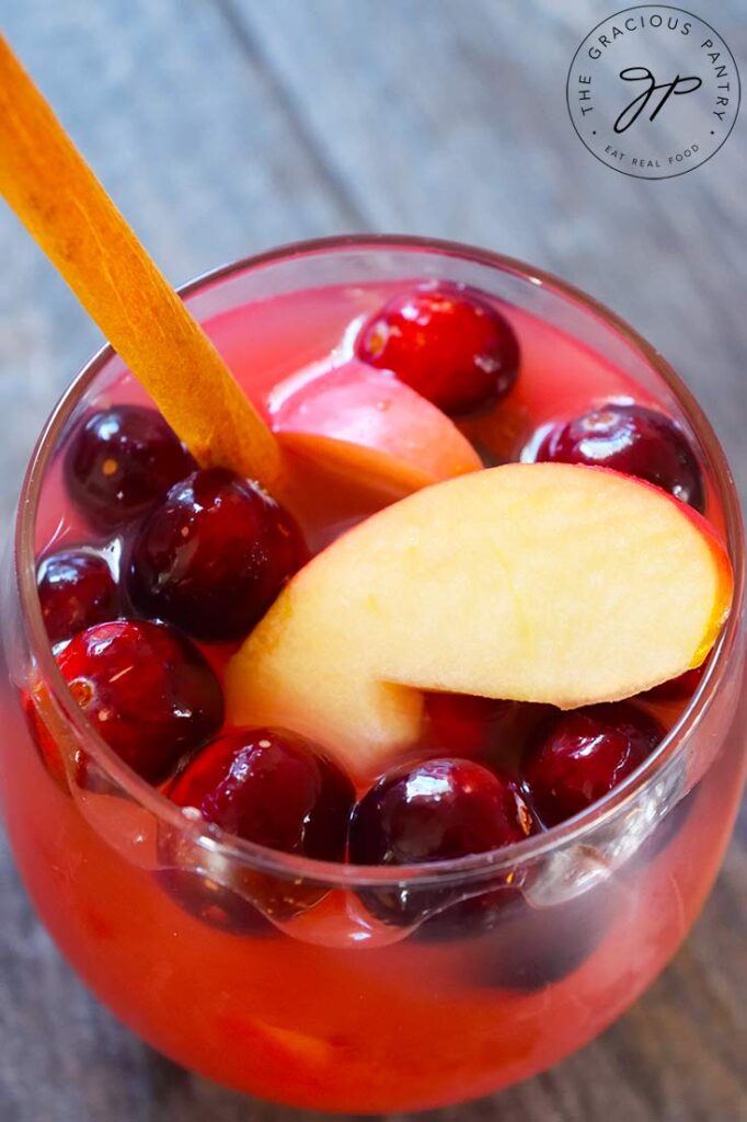 An overhead view looking down into a wine glass filled with Non Alcoholic Sangria.