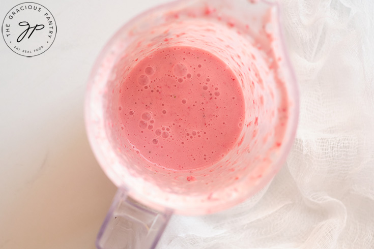 The Strawberry Smoothie blended and sitting in a blender cup.